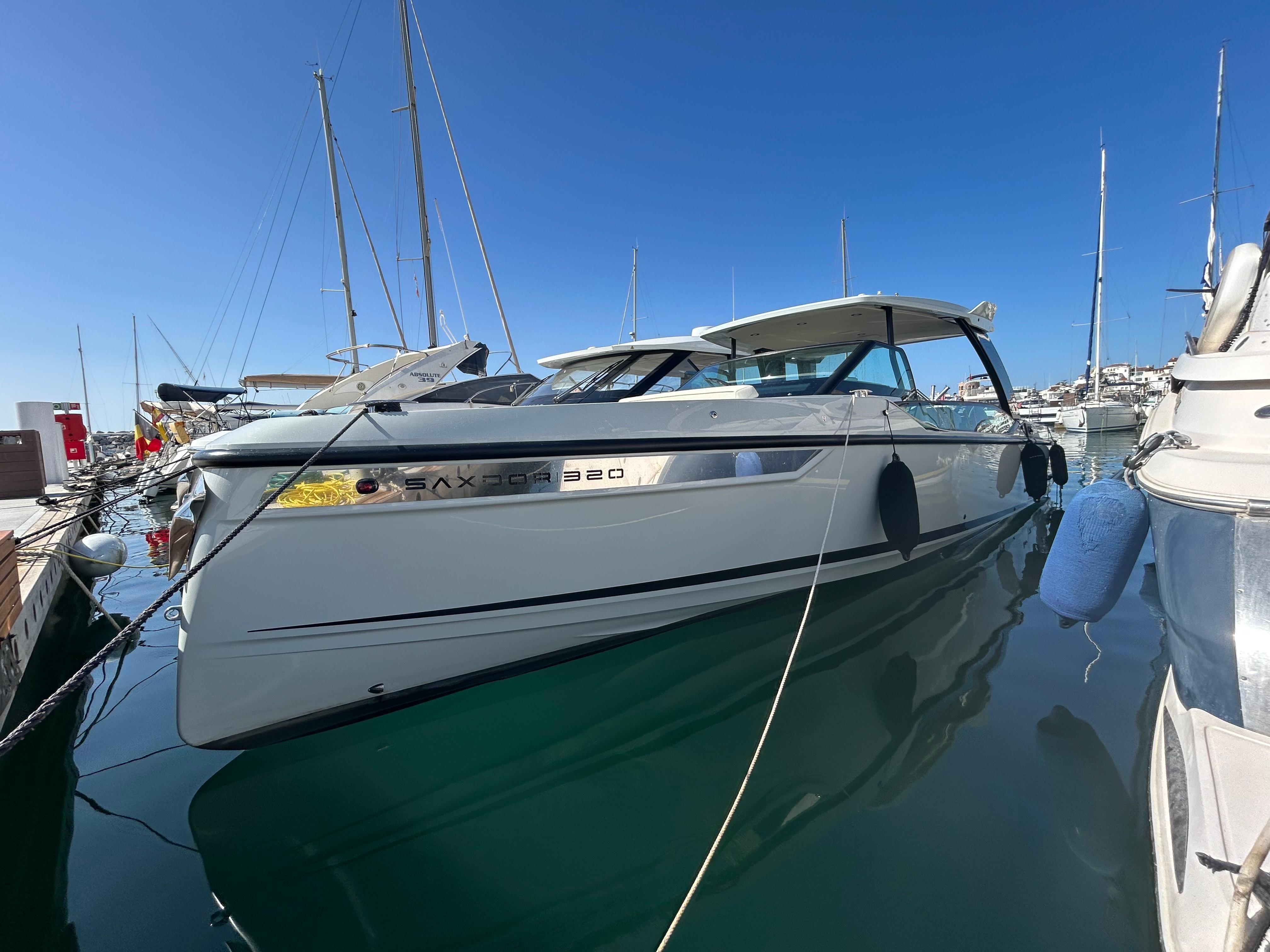 Saxdor 320 GTO 2024 Saxdor 320 GTO luxury boat docked in a marina under clear blue skies.