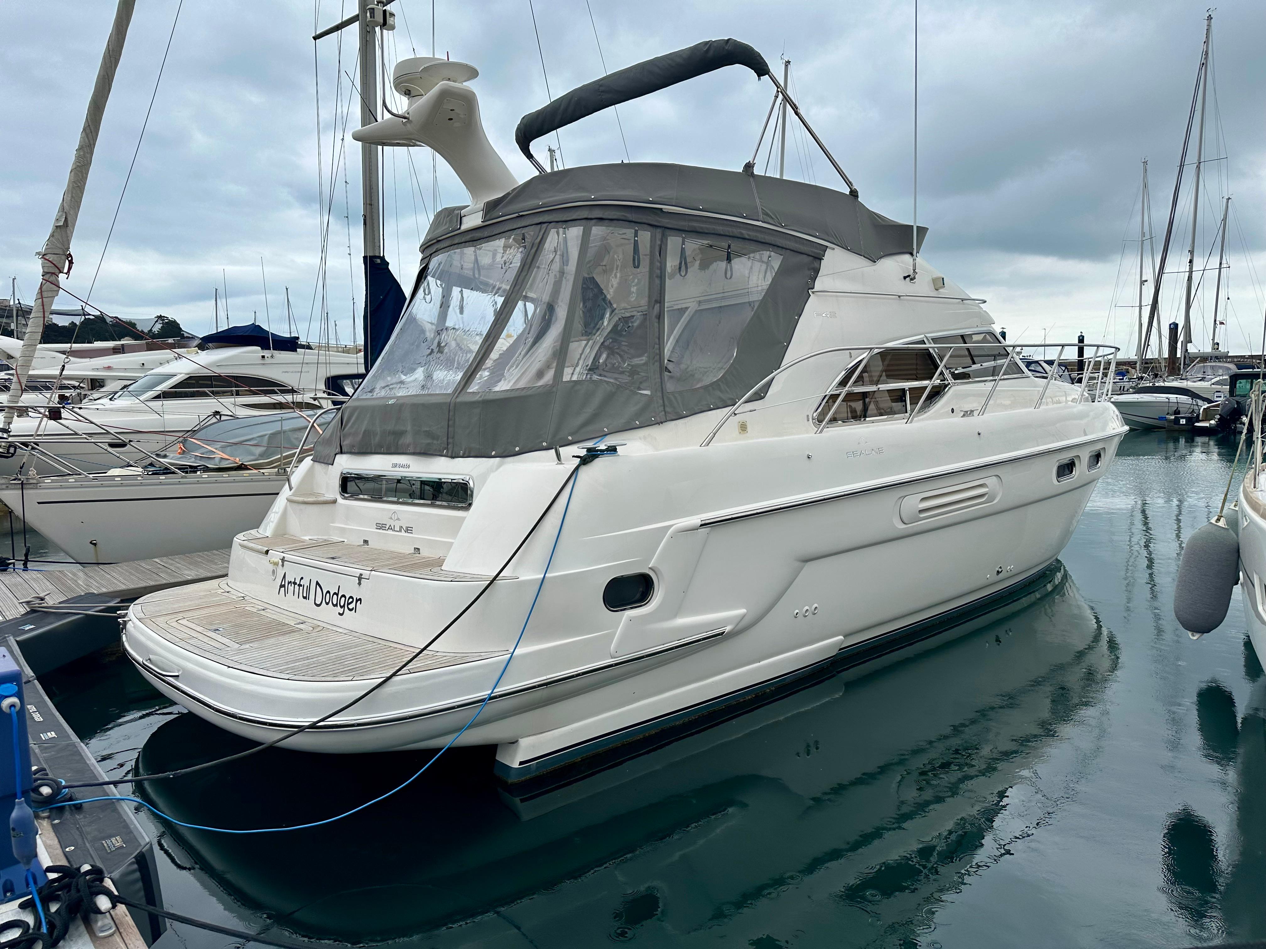 Sealine F43 2003 Sealine F43 yacht docked at marina, overcast sky.