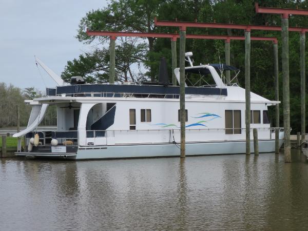 Monticello River Yacht Houseboat 1998 Monticello River Yacht Houseboat docked on a calm river.