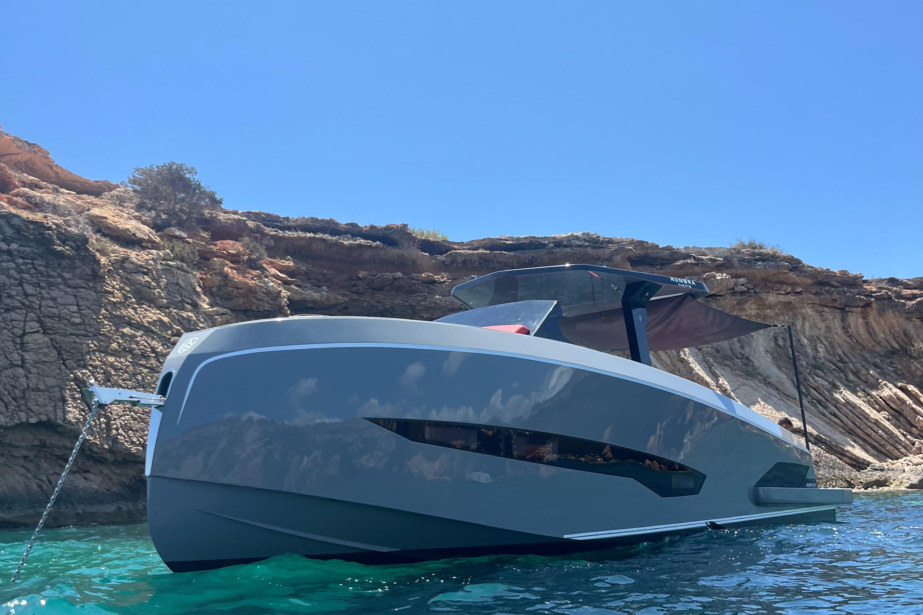 Kumbra 34 Futuristic Kumbra 34 yacht anchored near rocky cliffs, 2026 model.