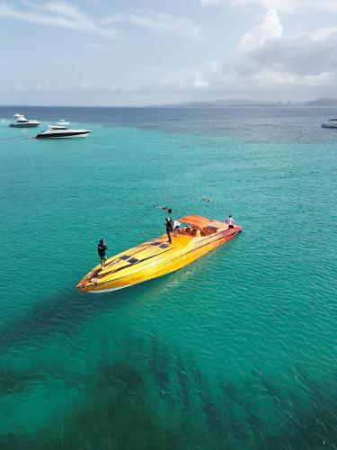 Nor-Tech Super V 5000 2006 Nor-Tech Super V 5000 speedboat on clear turquoise water.