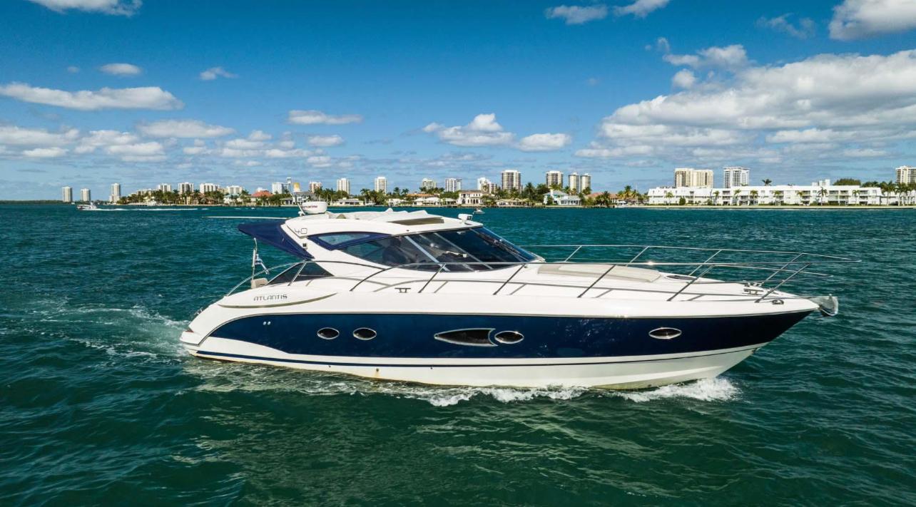 Azimut Atlantis 40 2011 Azimut Atlantis 40 yacht cruising on blue ocean near city skyline.
