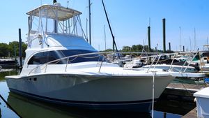 Luhrs 32 Convertible 1997 Luhrs 32 Convertible yacht docked at marina under clear blue sky.