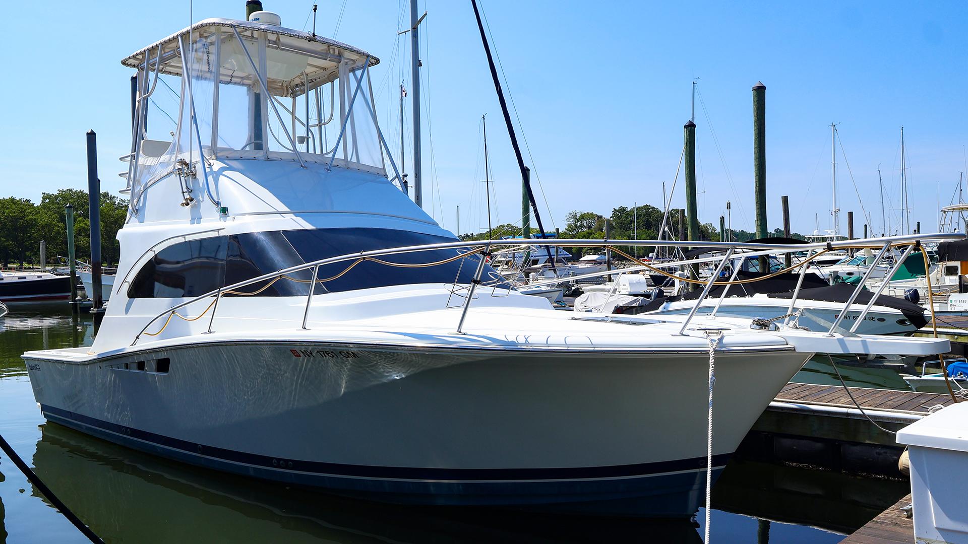 Luhrs 32 Convertible 1997 Luhrs 32 Convertible yacht docked at marina under clear blue sky.
