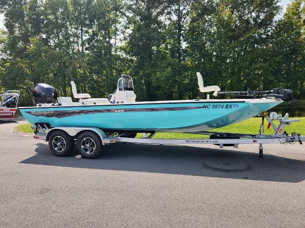 Ranger RB200 2022 Ranger RB200 boat on trailer, parked outdoors, with lush green trees in the background.
