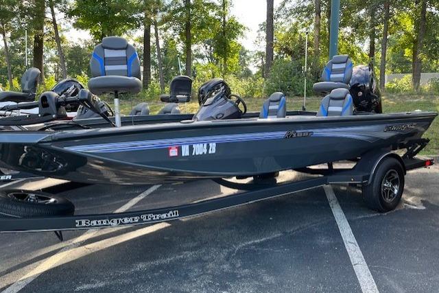 Ranger RT188P 2025 Ranger RT188P boat on trailer in wooded parking area.