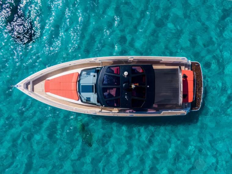 Fjord 48 Open Aerial view of 2015 Fjord 48 Open Mooring yacht on clear turquoise water.