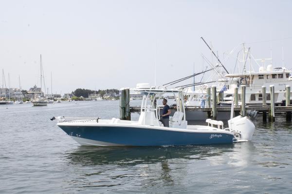 Yellowfin 26 Hybrid 2025 Yellowfin 26 Hybrid boat docked in a marina, featuring sleek design and modern amenities.