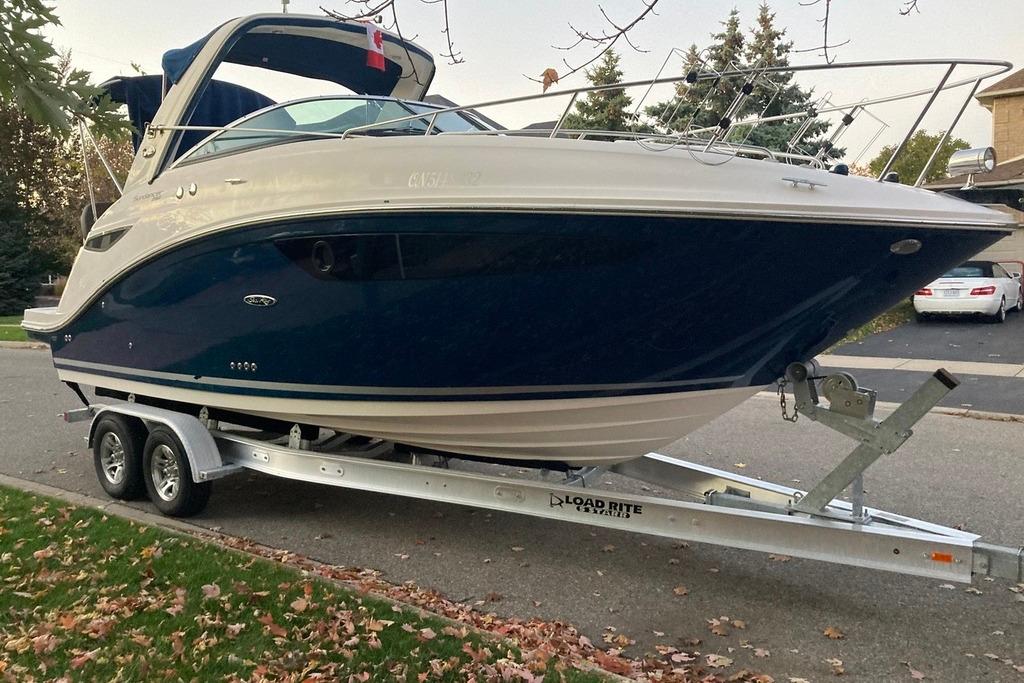Sea Ray 260 Sundancer 2014 Sea Ray 260 Sundancer boat on trailer, parked on a suburban street.