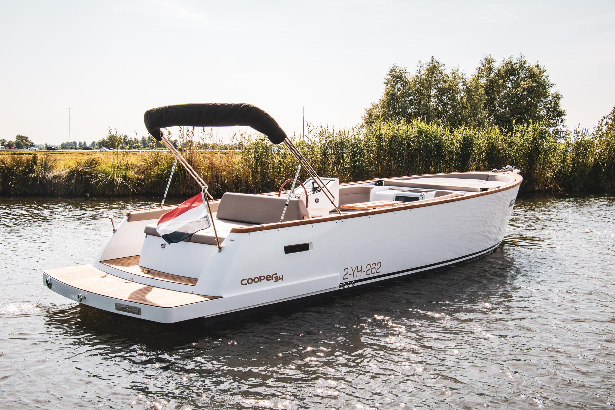 Cooper 34 2024 Cooper 34 boat on a calm river, featuring sleek design and comfortable seating.