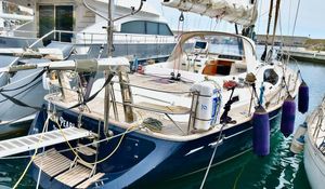 Oyster 56 Luxury Oyster 56 yacht, 2009 model, docked in marina with sleek design and wooden deck.