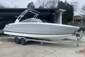 Cobalt R8 2022 Cobalt R8 boat on trailer, parked outside a garage.