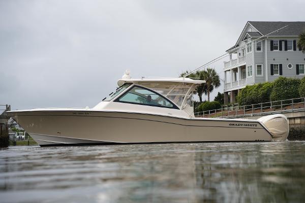Grady-White Freedom 375 2020 Grady-White Freedom 375 boat near a waterfront house on a cloudy day.