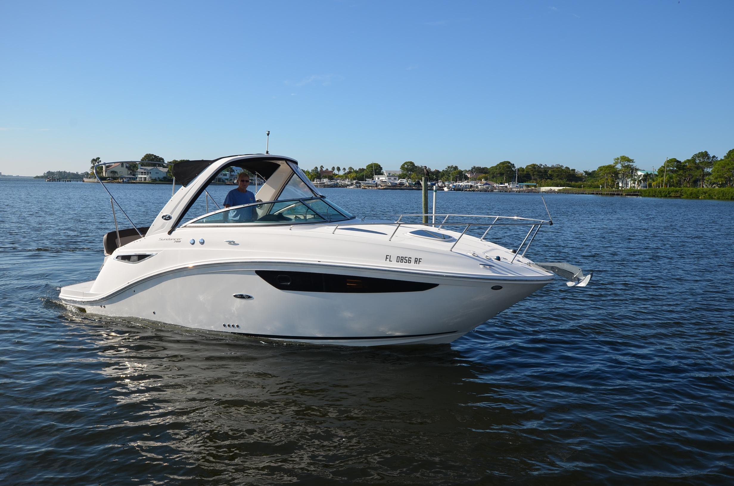 Sea Ray 260 Sundancer 2015 Sea Ray 260 Sundancer cruising on a calm lake under clear blue skies.