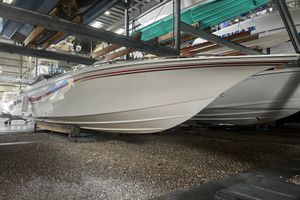 Fountain 42 Executioner 2009 Fountain 42 Executioner boat stored indoors on gravel surface.