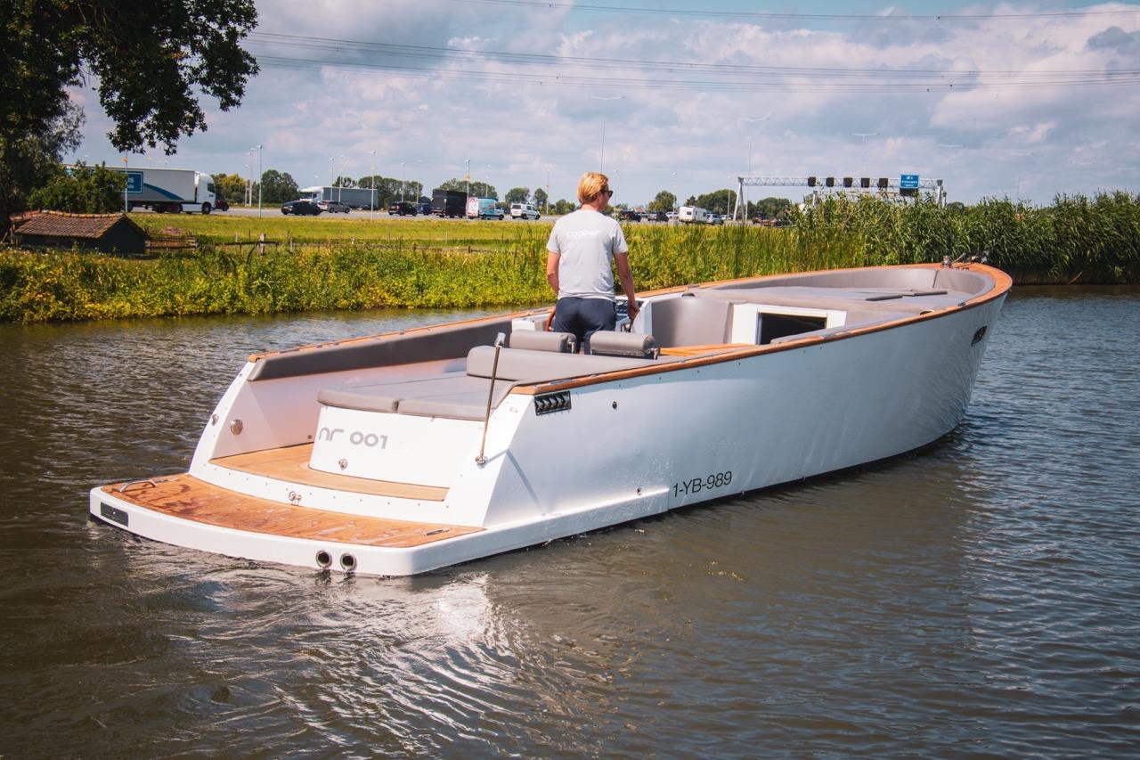 Cooper 1000 A 2018 Cooper 1000 boat cruising on a calm river with a person steering.