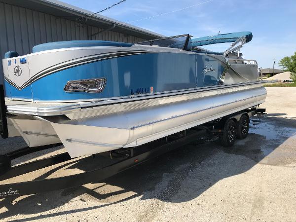 Avalon LSZ Elite Windshield 2023 Avalon LSZ Elite Windshield pontoon boat in blue, parked on a trailer.