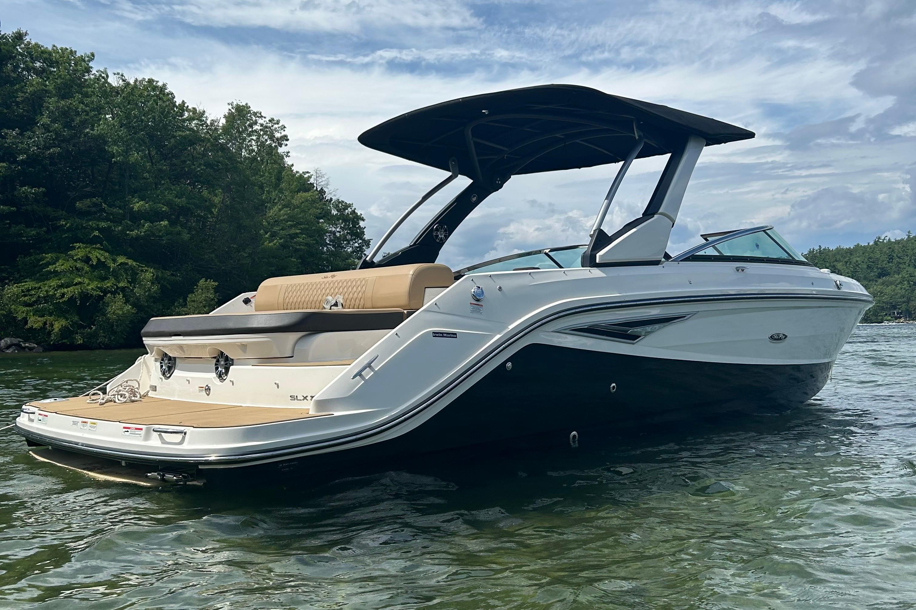 Sea Ray SLX 280 2021 Sea Ray SLX 280 boat on a serene lake with lush greenery.