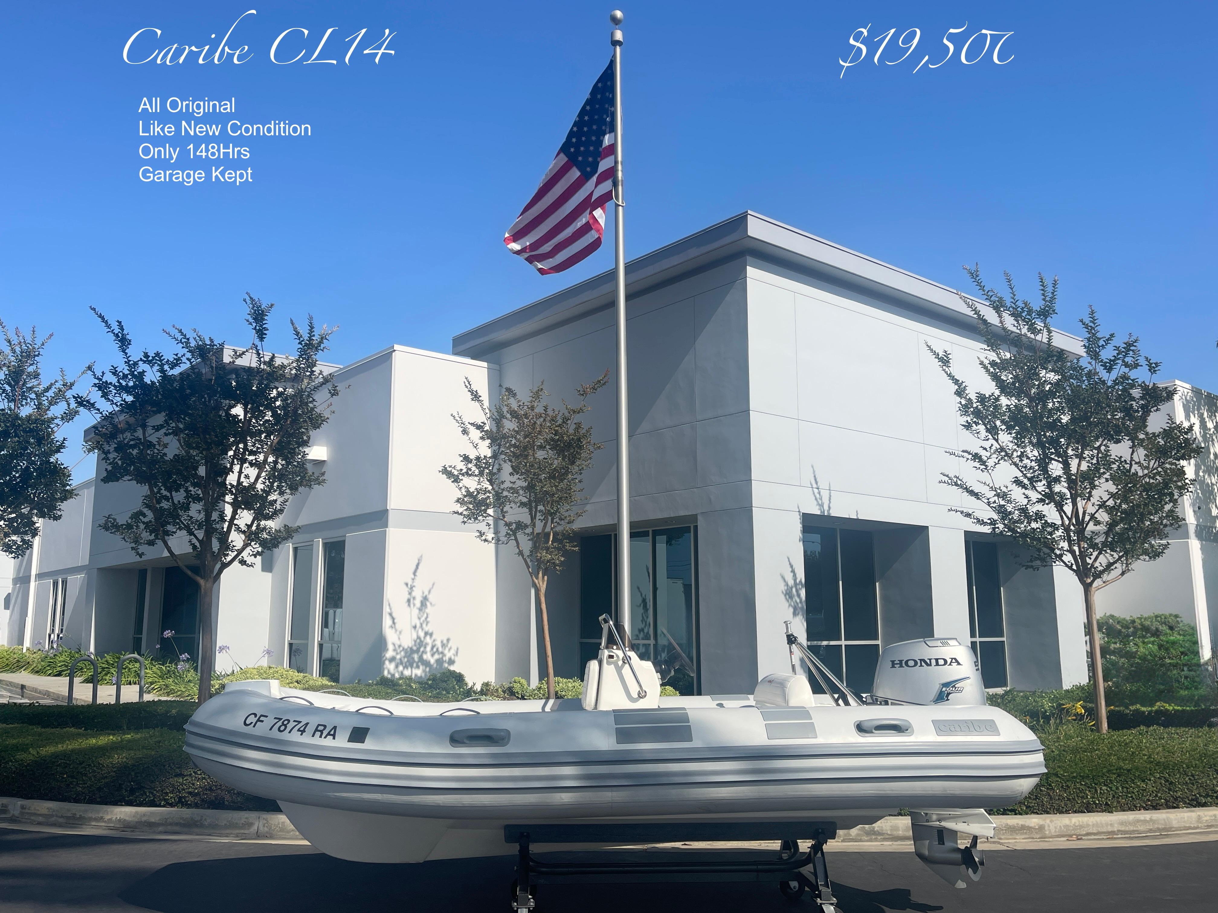 Caribe CL14 2003 Caribe CL14 inflatable boat, excellent condition, displayed outdoors with American flag.