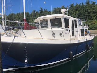 American Tug 34 Pilothouse 2010 American Tug 34 Pilothouse boat docked in a serene marina setting.