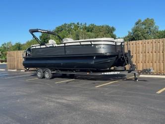 Regency 250 LE3 2024 Regency 250 LE3 pontoon boat on trailer in parking lot.