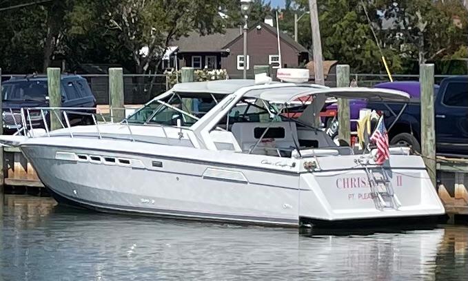 Chris-Craft 336 Amerosport 1987 Chris-Craft 336 Amerosport boat docked at a marina with American flag.