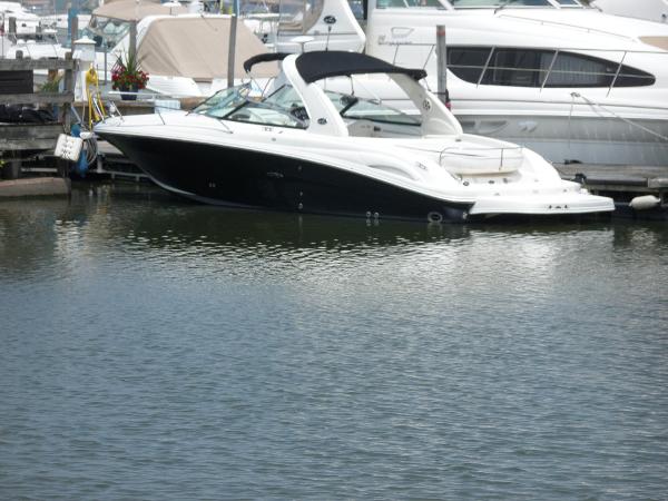 Sea Ray 290 SS 2005 Sea Ray 290 SS boat docked in a marina, surrounded by other vessels.