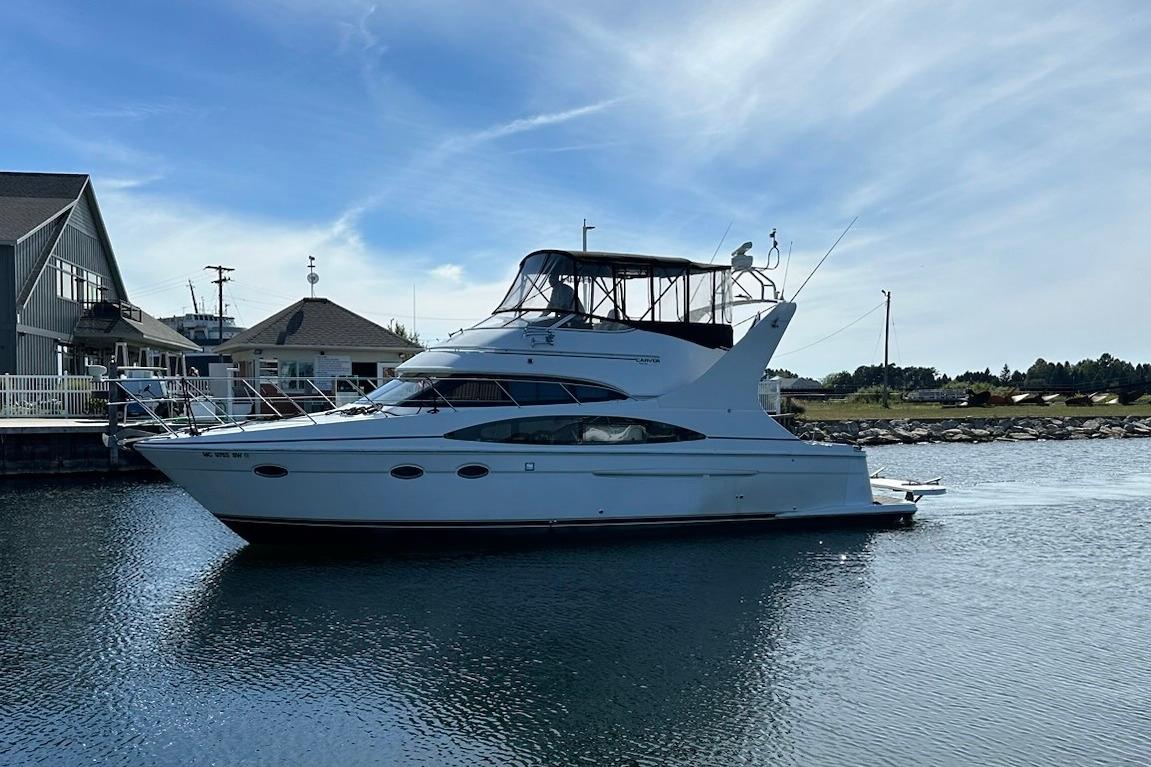 Carver 410 Sport Sedan 2002 Carver 410 Sport Sedan yacht docked in a serene marina setting.