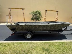Tracker Grizzly 2072 Utility 2025 Tracker GRIZZLY 2072 Utility boat on trailer, parked outdoors.