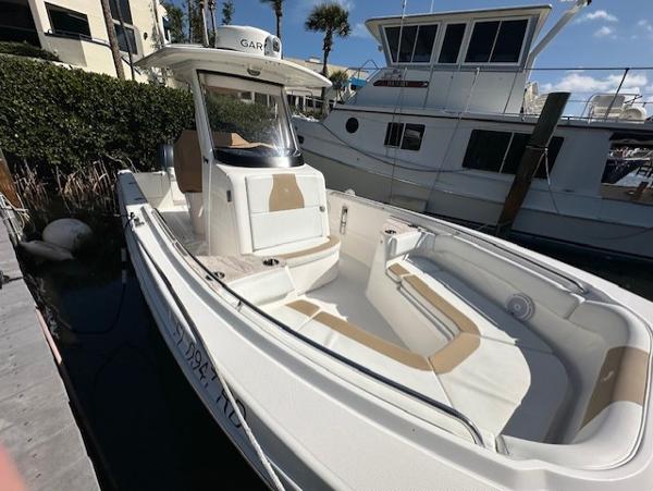 Edgewater 262CC 2016 Edgewater 262CC boat docked, featuring spacious seating and sleek design.