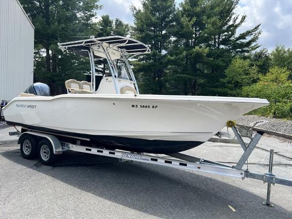 Key West 239FS 2019 Key West 239FS boat on trailer, parked outdoors near trees.