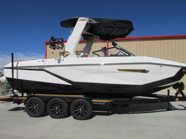 Nautique G23 2026 Nautique G23 boat on trailer, white and black design, parked outdoors.