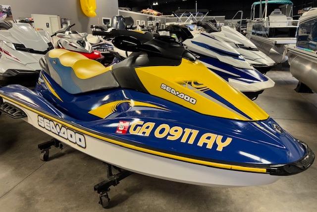 Sea-Doo GTI SE 2006 Sea-Doo GTI SE jet ski in showroom, blue and yellow design, side view.