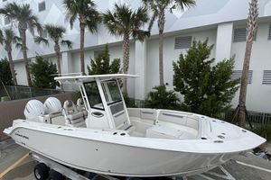 Sailfish 252 CC 2026 Sailfish 252 CC boat with dual engines, parked near palm trees.