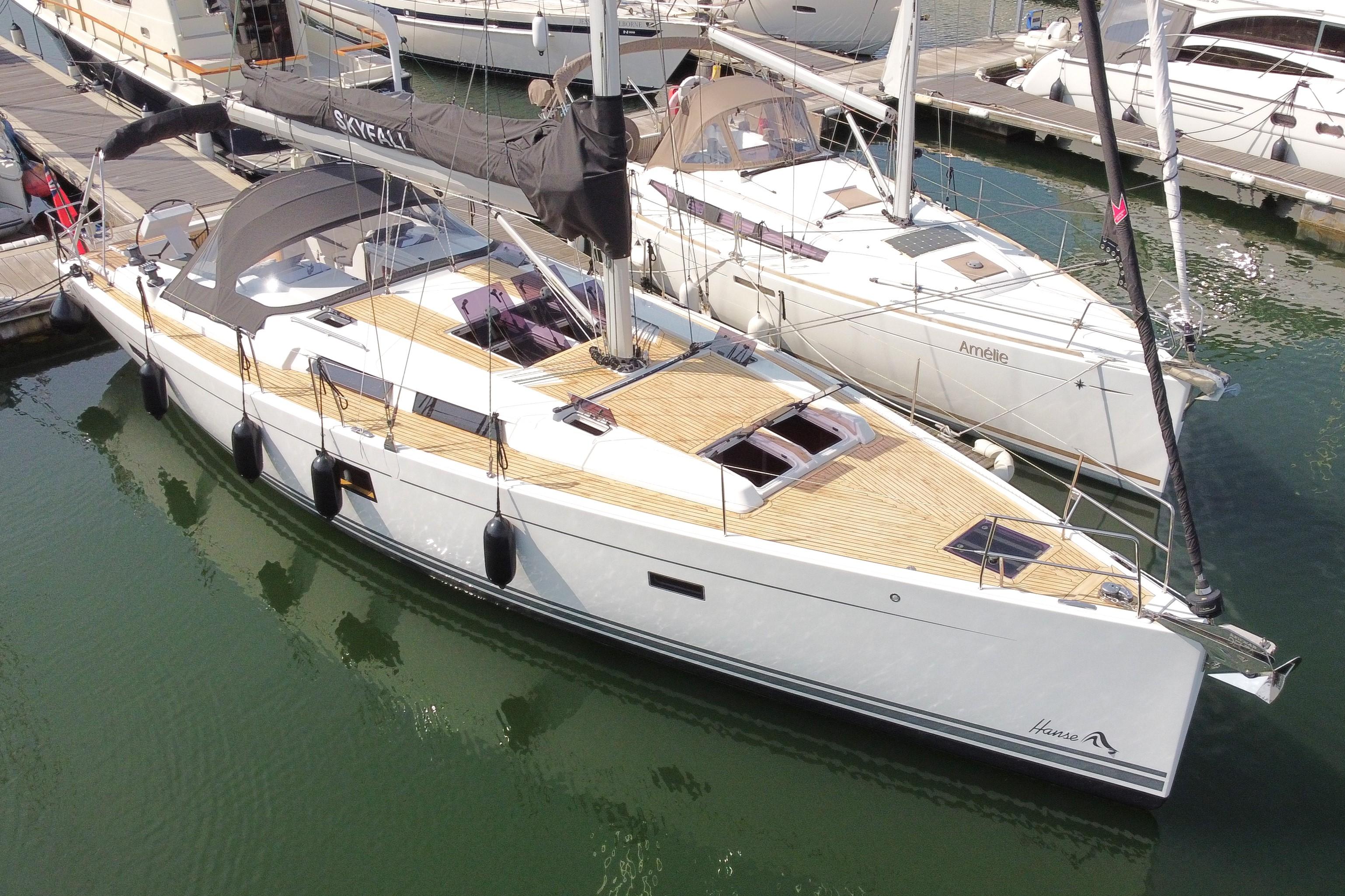 Hanse 455 2014 Hanse 455 yacht docked at marina, featuring sleek design and spacious deck.