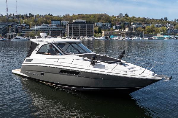 Regal 35 Sport Coupe 2018 Regal 35 Sport Coupe cruising on a calm lake with cityscape background.