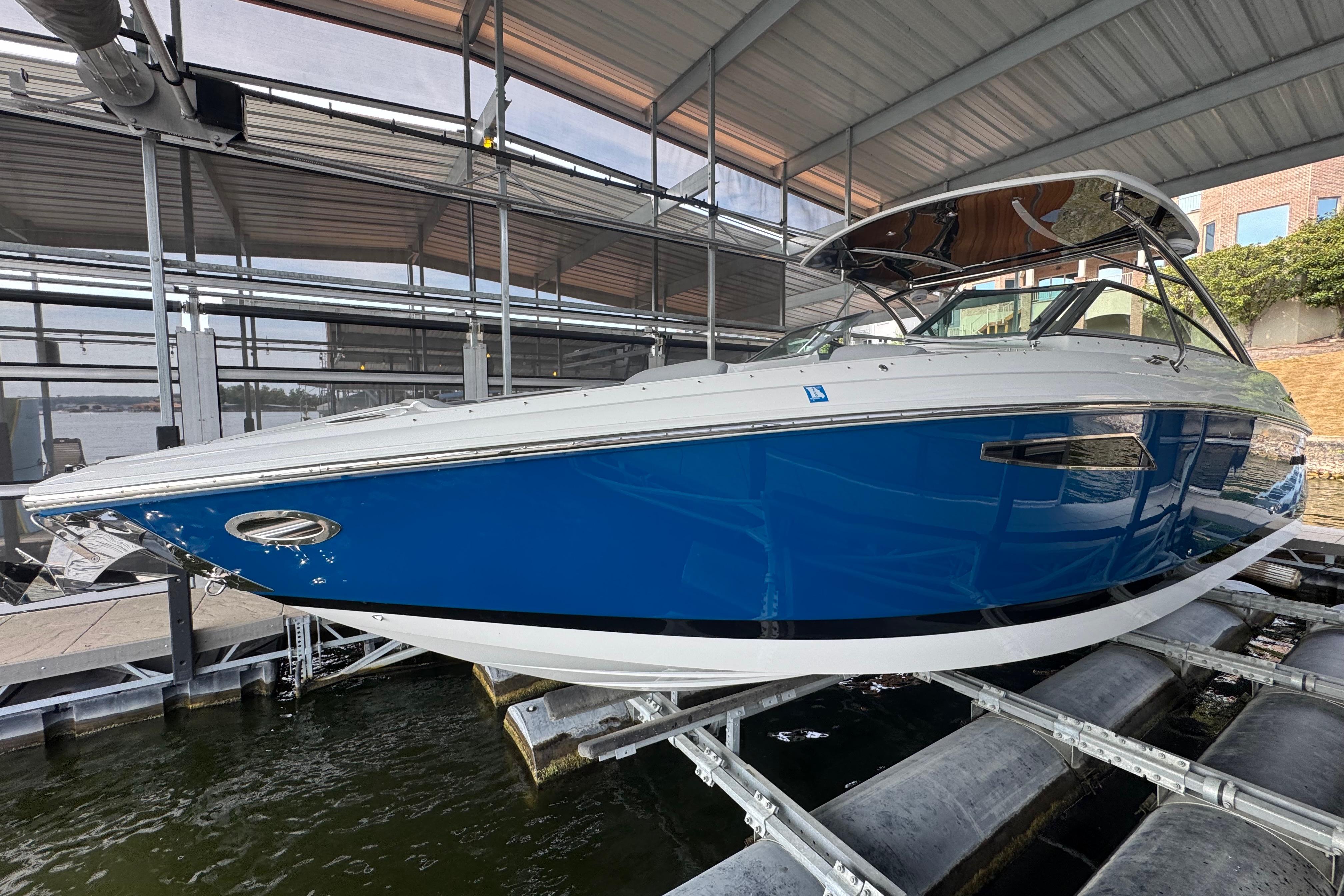 Cobalt R35 2022 Cobalt R35 boat in blue, docked under a covered marina.