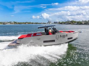 De Antonio Yachts D42 Open 2023 De Antonio Yachts D42 Open cruising on a sunny day, featuring sleek design and vibrant red seating.