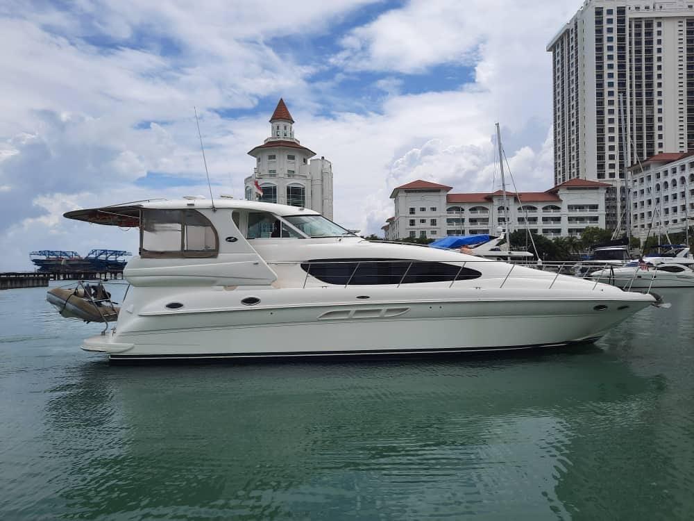 Sea Ray 480 Motor Yacht 2002 Sea Ray 480 Motor Yacht docked near luxury waterfront buildings.