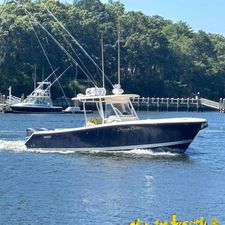 Pursuit C 310 Center Console 2014 Pursuit C 310 Center Console boat cruising on a sunny day.
