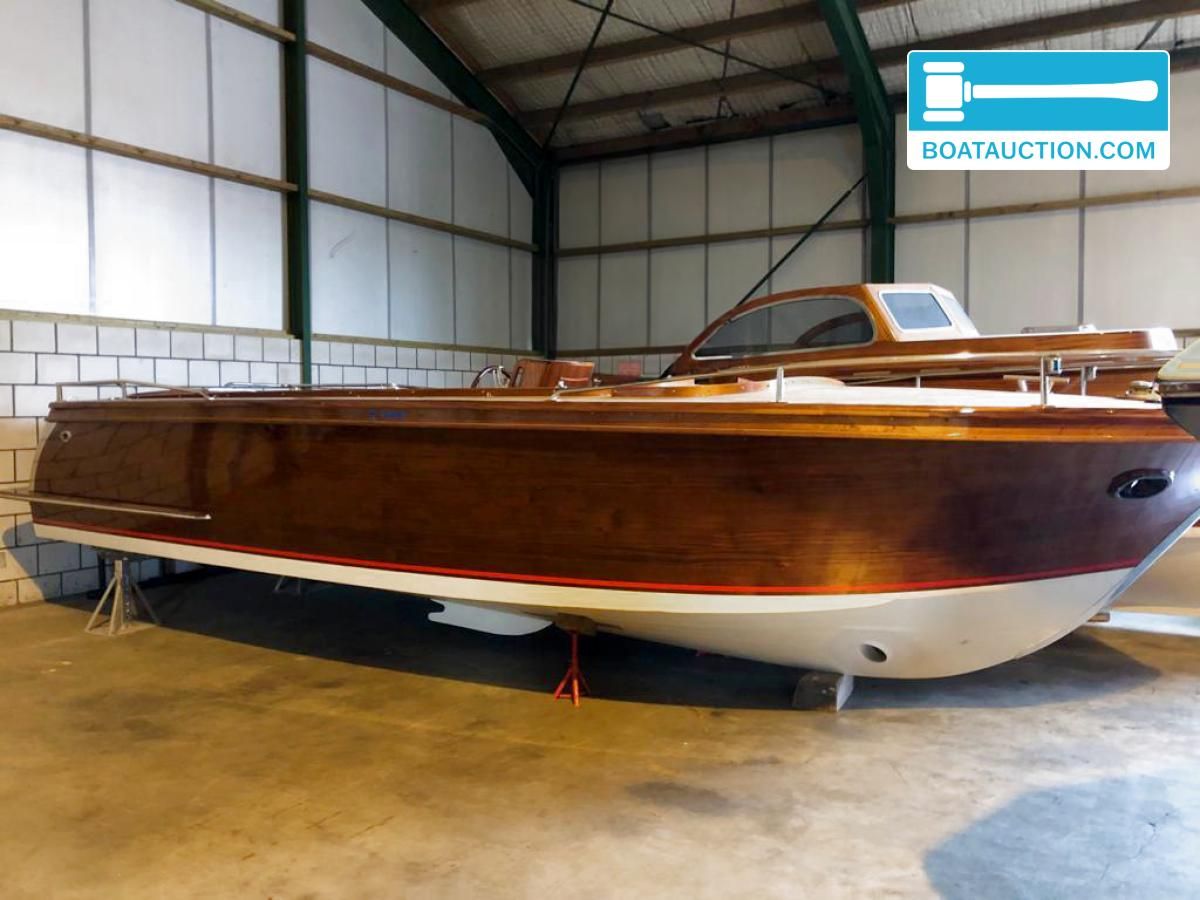 Beaver Sundeck 27 1998 Beaver Sundeck 27 boat in storage, showcasing sleek wooden design.