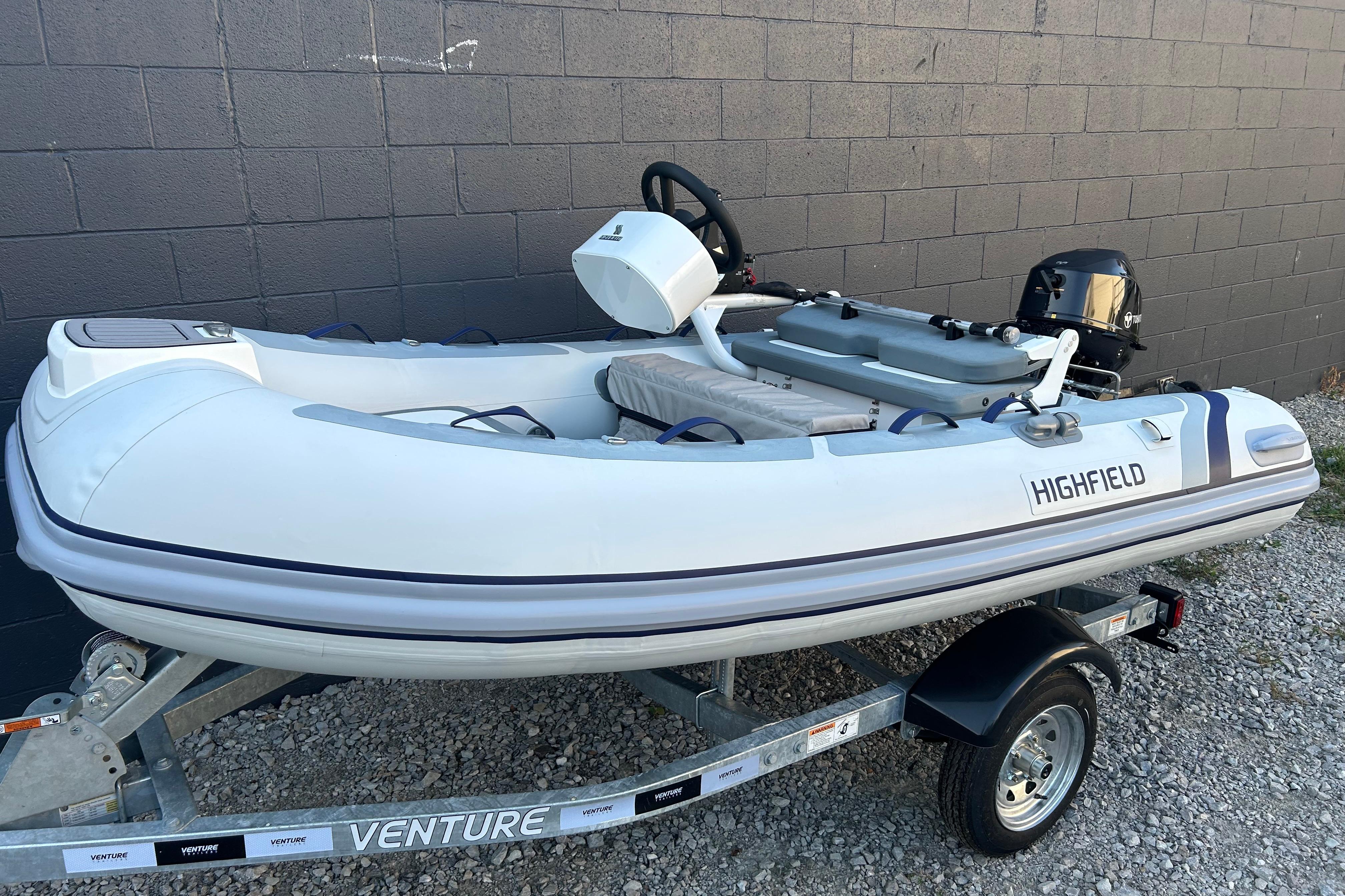 Highfield Classic 310 FCT 2024 Highfield Classic 310 FCT inflatable boat on trailer, parked by a wall.