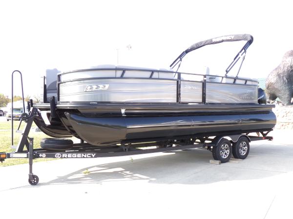 Regency 230 DL3 2024 Regency 230 DL3 pontoon boat on trailer, sleek design, black and gray finish.