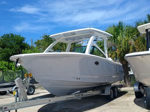 Robalo R257 Dual Console 2025 Robalo R257 Dual Console boat on trailer, surrounded by palm trees.