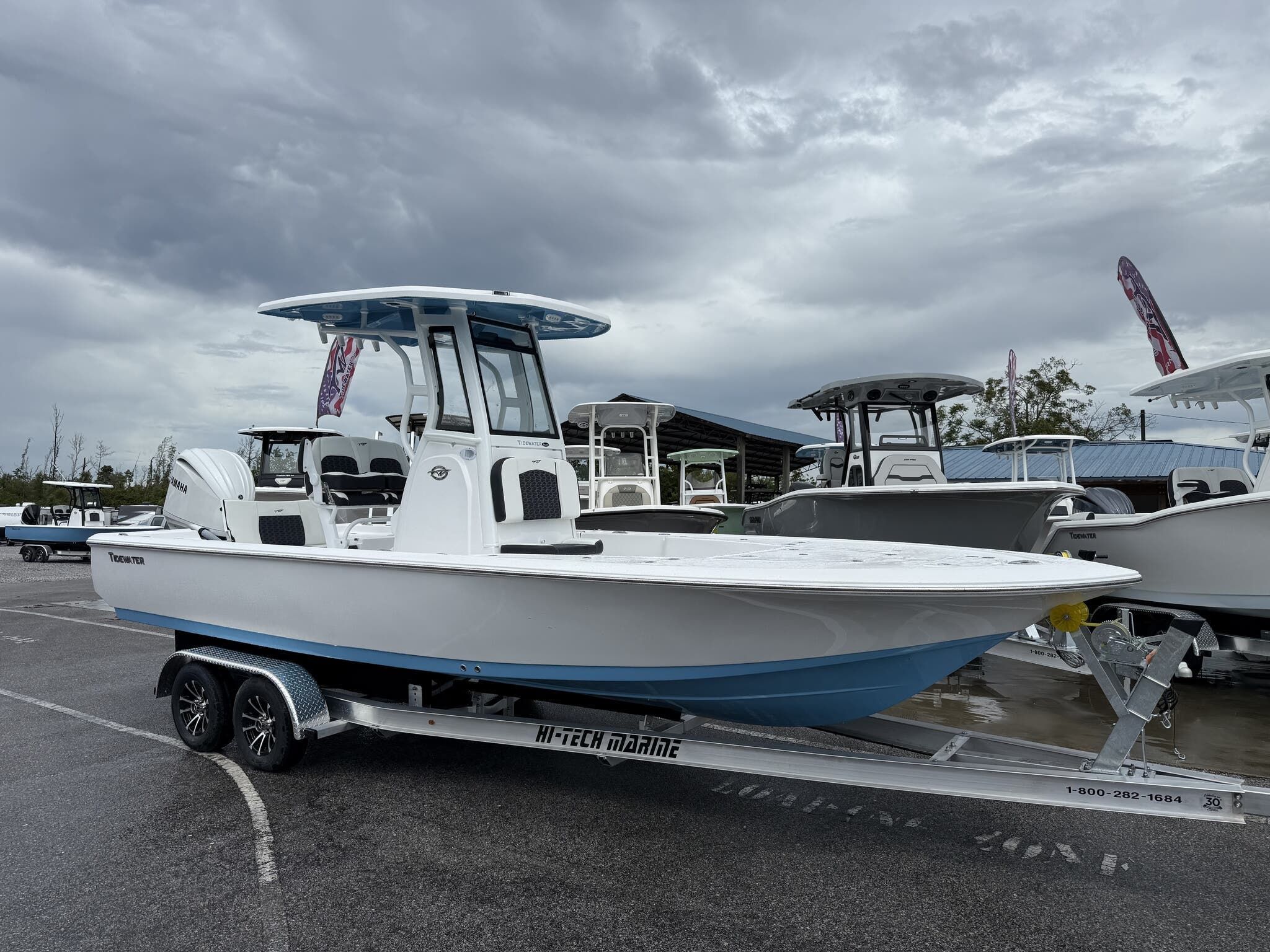 Tidewater 2410 Bay Max 2026 Tidewater 2410 Bay Max boat on trailer, parked outdoors under cloudy sky.