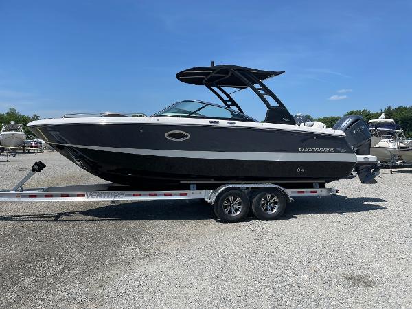 Chaparral 250 OSX 2024 Chaparral 250 OSX boat on trailer, sleek black design, sunny day.