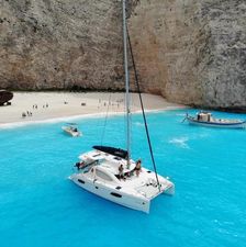 Leopard 39 Catamaran Leopard 39 sailing in turquoise waters near a rocky beach, 2014 model.