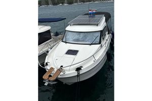 Beneteau Antares 8 2022 Beneteau Antares 8 OB with solar panels, docked in a marina.