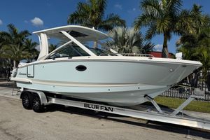 Chaparral 280 OSX 2024 Chaparral 280 OSX boat on trailer, surrounded by palm trees.