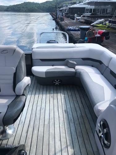 Crest Caliber 2018 Crest Caliber boat with comfortable seating and scenic lake view.